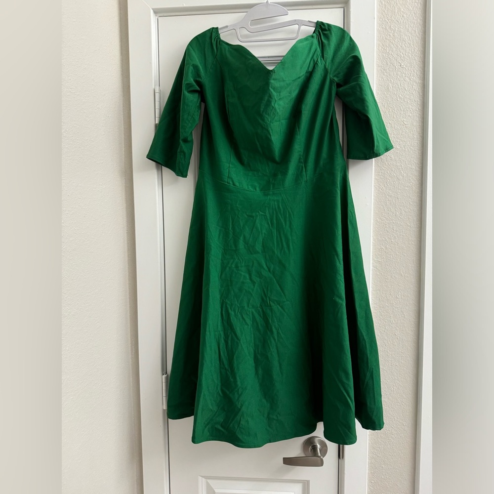 Green off the shoulder dress.